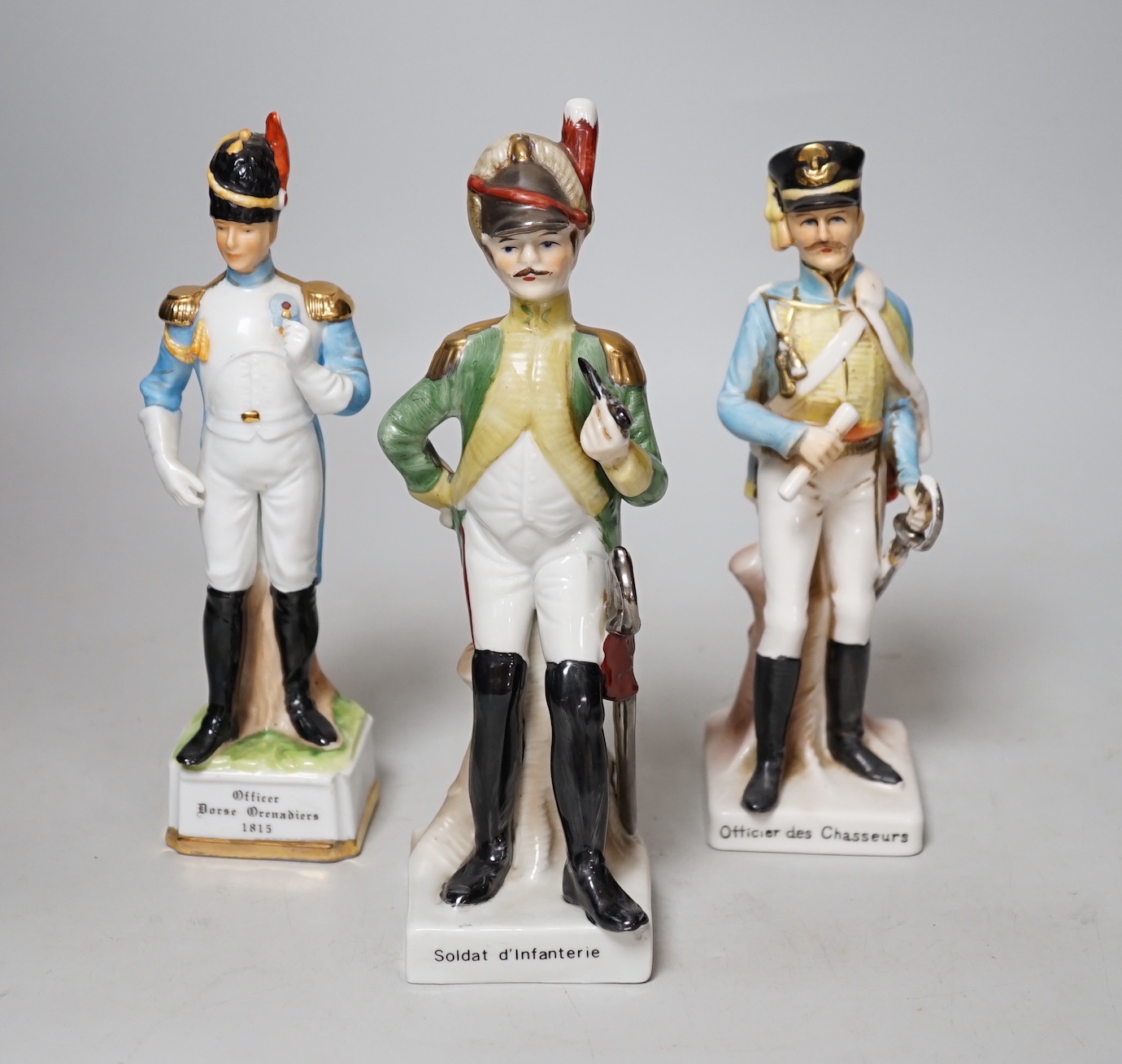 Twenty porcelain figures of soldiers including Officer Light Dragoon and Rifle Brigade, largest 31cm high